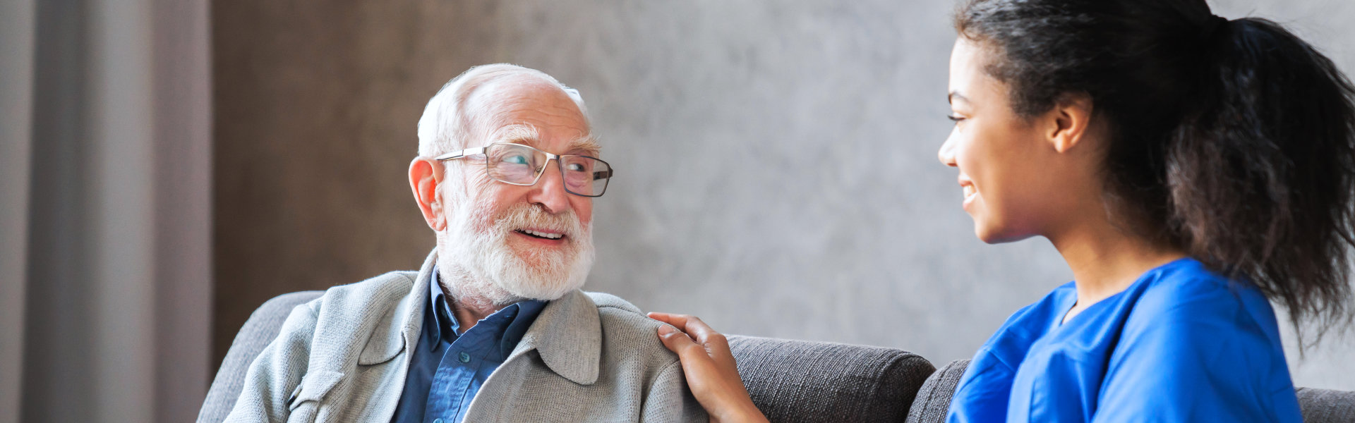 aide and elderly man talking